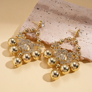 Macro detail of vintage gold flower earrings with CZ inlay and S925 silver needle stamp