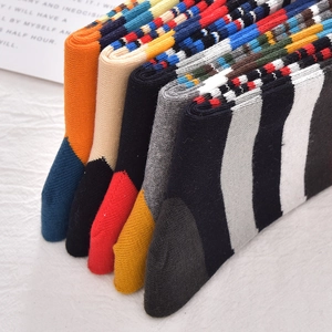 Five pairs of men's colorful striped cotton crew socks with geometric knit patterns
