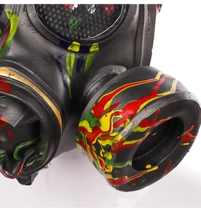 Macro detail of steampunk gas mask featuring colorful paint splatter on black latex