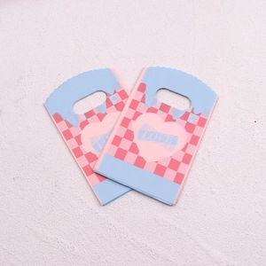 Detailed view of mini jewelry gift bag with blue checkerboard and pink heart pattern