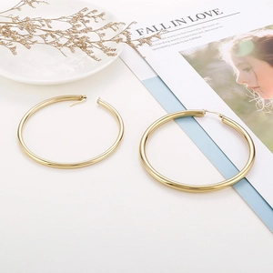 Close-up of classic 18K gold plated hoop earrings with professional still life styling