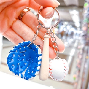 Detailed close-up of a baseball keychain set with mini glove, wooden bat and ball
