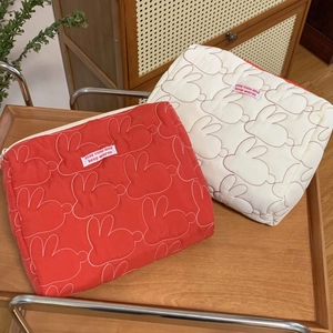 Quilted cotton bunny cosmetic bags in red and cream white on a decorative tray
