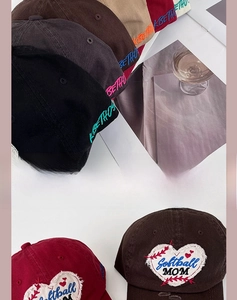 Detail of embroidered heart patch and Softball MOM text on cotton baseball cap