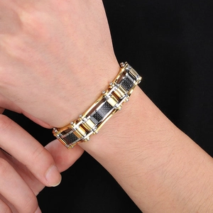 Macro detail of men's tri-color steel chain bracelet with carbon fiber inlays on wrist