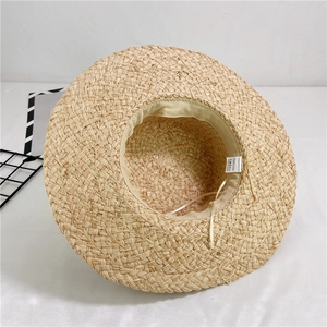 Detail of the inner sweatband and 100% papyrus straw label inside the sun hat