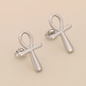 Macro shot of silver polished stainless steel Ankh cross earrings with butterfly backings