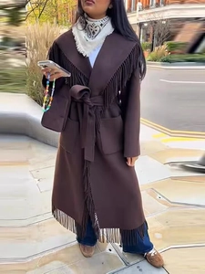 Detail of dark brown wool coat featuring elegant fringe trim and a matching waist belt