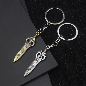 Vintage bronze and silver Taoist sword keychains with detailed metal relief patterns