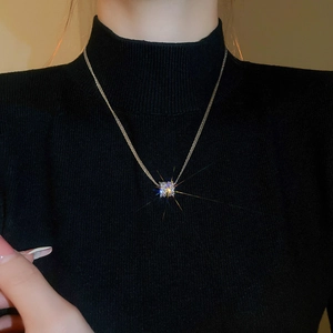 Detailed view of square zircon pendant necklace showing sparkling cross-star light effects