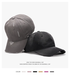 Close-up of distressed vintage baseball caps in dark grey and black with worn texture