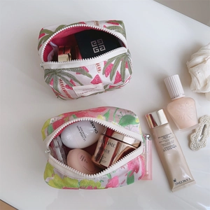 Detailed view of floral jacquard cosmetic bags with smooth zippers and spacious interior