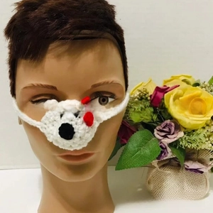 Detailed view of hand-knitted white crochet bear nose warmer with ear loops on mannequin
