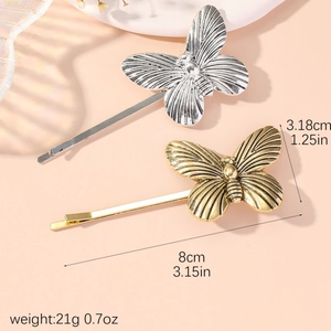 Elegant gold and silver butterfly hair clips with size and weight measurements included