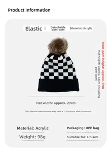 Detail of checkered knit beanie with detachable faux fur pom and acrylic texture