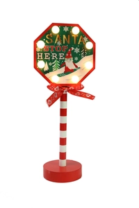 Close-up of Santa Stop Here LED wooden sign with eight warm bulbs and red bow
