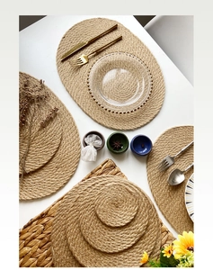 Macro detail of round jute placemats with rustic hand-woven natural hemp fiber texture