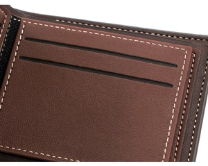 Detailed close-up of brown leather wallet interior with fine stitching and card slots