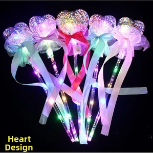 Detail showing glowing heart LED wands with colorful ribbons and mesh decorations