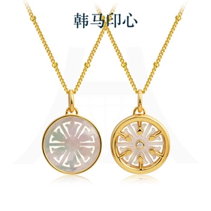 Close-up of 18K gold-plated 925 silver necklaces with white mother of pearl and fine diamonds