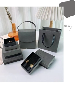 Minimalist dark gray jewelry packaging set with rigid gift boxes and matching paper bags