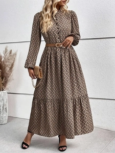 Detail of elegant snake print maxi dress with long sleeves and matching brown buckled belt