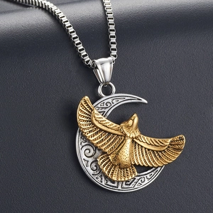 Detailed view of stainless steel necklace with golden eagle and silver moon pendant