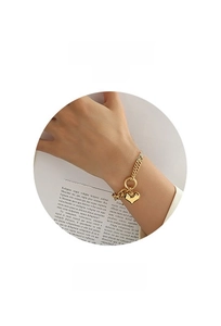 Detailed view of gold plated heart charm bracelet with elegant toggle clasp and double chain