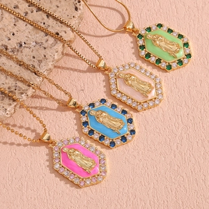 Detail of 18K gold-plated hexagonal Virgin Mary pendants with colorful enamel and zircon