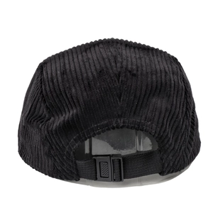 Rear view of black corduroy 5-panel cap with adjustable nylon strap and plastic buckle