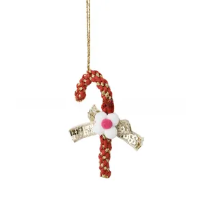 Detailed view of red and gold Christmas candy cane hanging ornament with sequin bow decoration