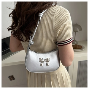 Silver PU leather underarm bag with a metal butterfly detail and knotted shoulder strap