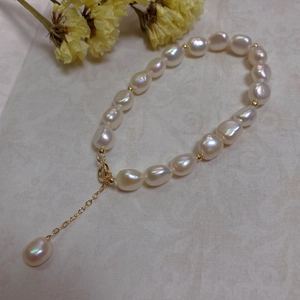 Detailed view of baroque pearl bracelet with 14K gold filled clasp and adjuster chain