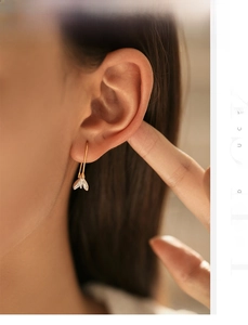 Elegant s925 silver magnolia drop earrings on model with golden hooks and clear petals