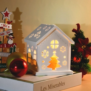 Warm white Christmas house candle holder with cutout snowflake patterns for holiday decor