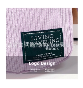 Detailed view of light purple corduroy fabric with a black rectangular logo patch