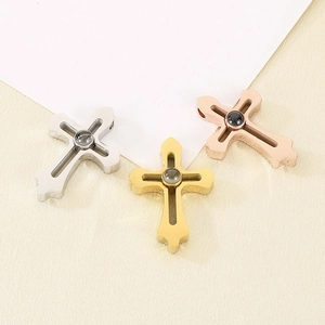 Detailed view of silver, gold, and rose gold cross pendants with projection stones