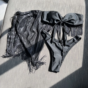 Three-piece black fringe bikini set with strapless bandeau top and striped mesh cover-up