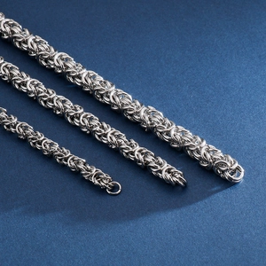 Three silver stainless steel Byzantine chains in different widths with detailed link weaving