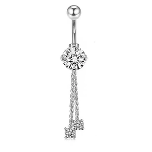 Macro detail of silver navel ring with round cubic zirconia and elegant tassel chains