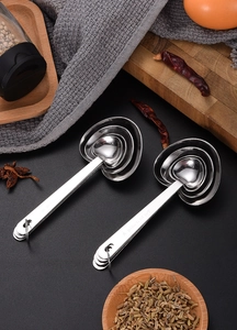 Macro shot of heart-shaped stainless steel measuring spoons on kitchen counter
