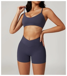Detail of high-stretch dark grey-purple sports bra and V-cross high waist yoga shorts set
