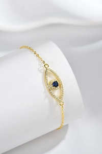 Detailed close-up of golden S925 sterling silver evil eye bracelet with blue zircon inlay