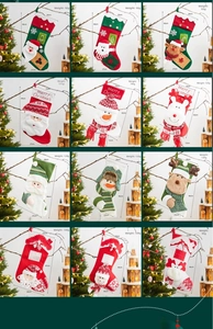 Close-up of 12 assorted large Christmas stockings featuring Santa and Snowman designs