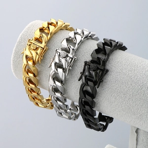 Three-piece Cuban link bracelet set in gold silver and black steel on a display