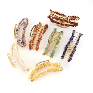 Detail of banana-shaped hair claws with handmade wire-wrapped colorful natural crystals