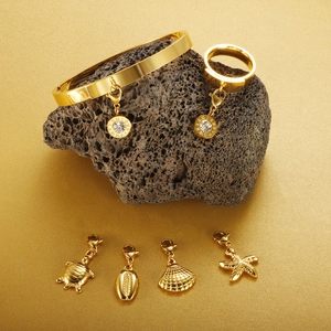 18K gold plated ocean style jewelry set with Roman numeral charms on volcanic stone