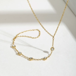 18K gold plated stainless steel bracelet featuring round zircon stones on a white background