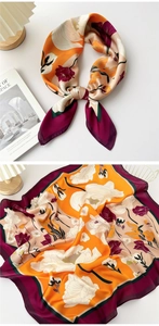 Detail of floral silk scarf in orange and purple with soft silk texture and print