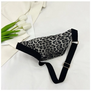 Close-up of leopard print waist bag with adjustable black strap and golden metal hardware